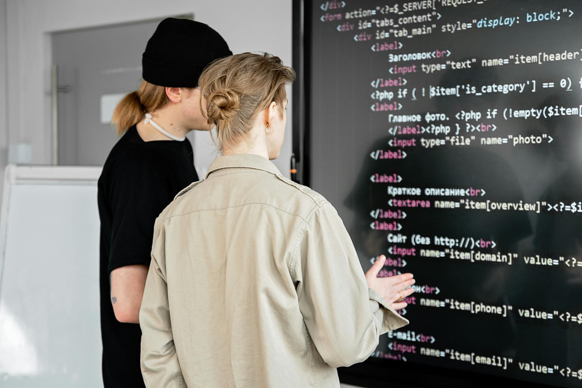 men looking at the code on the board