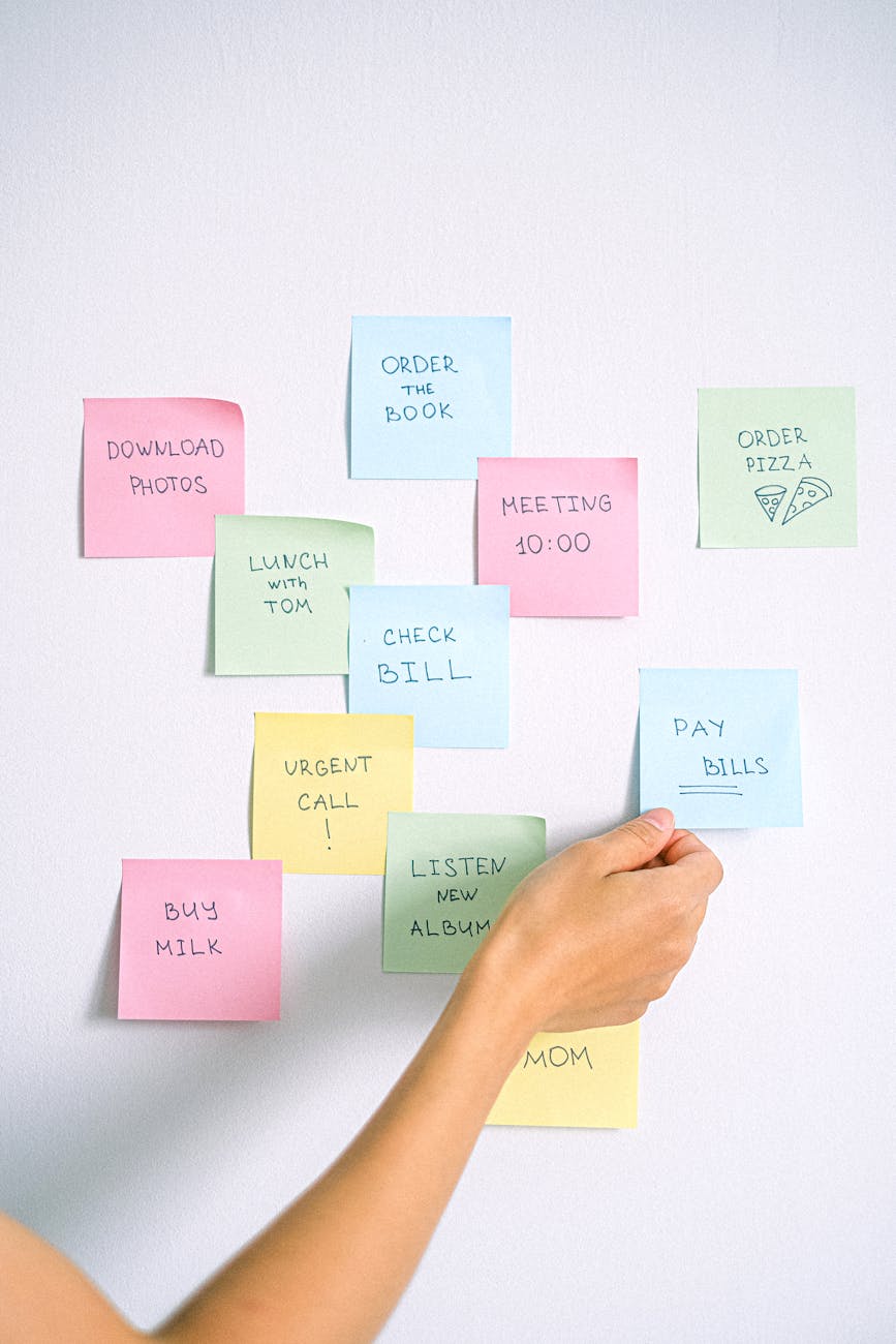 a person holding blue sticky note