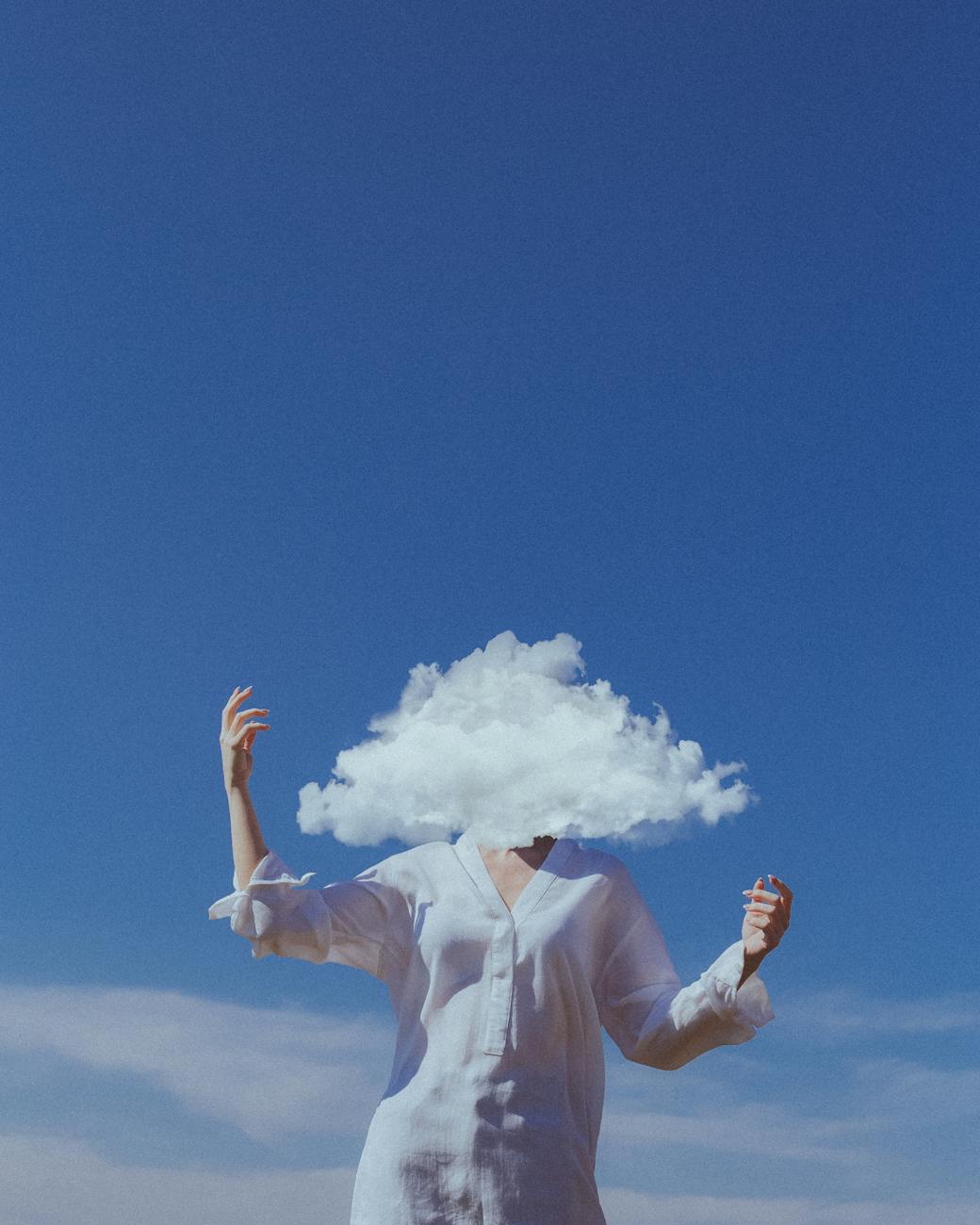 head in cloud with blue sky in background